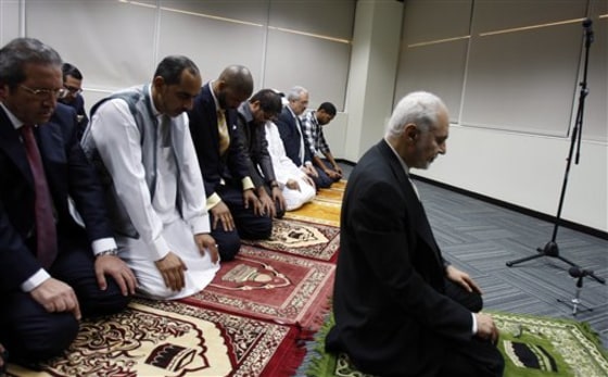 Imam Feisal Abdul Rauf, right, leads the prayers during an Iftar ceremony hosts by Dubia Scholl of Government in Dubai, United Arab Emirates onTuesday.